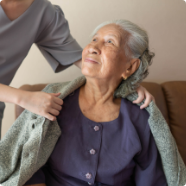Elderly woman receiving help